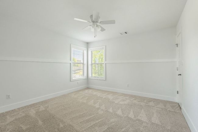 Spare room featuring carpet floors, visible vents, ceiling fan, and baseboards | Image 27
