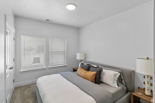Carpeted bedroom featuring baseboards and visible vents | Image 15