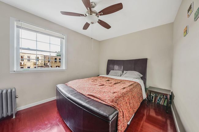 Bedroom with hardwood floors, and a ceiling fan | Image 19