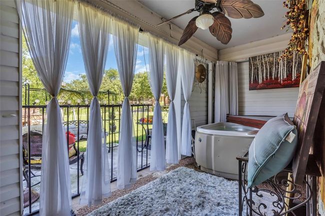 Sunroom / solarium with a ceiling fan | Image 37