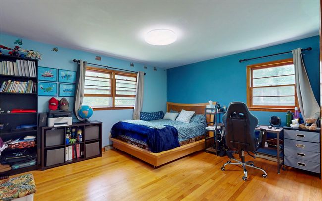 Bedroom featuring wood finished floors | Image 32