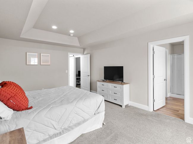 Bedroom with baseboards, recessed lighting, a raised ceiling, and light colored carpet | Image 13