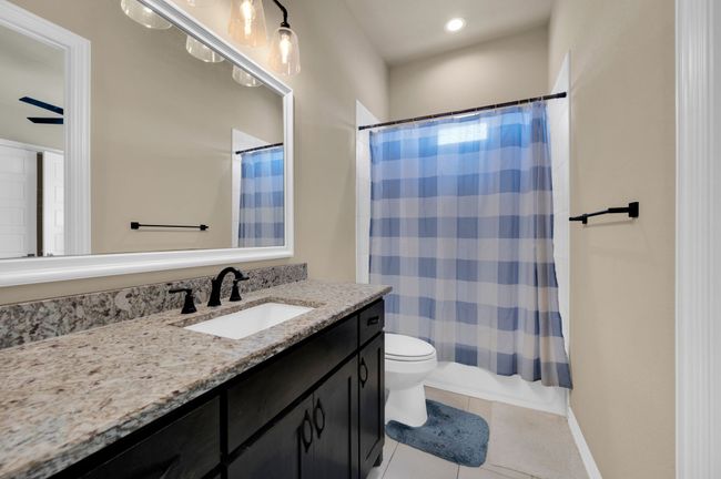 Bathroom featuring vanity, tile patterned flooring, recessed lighting, and shower / bath combo | Image 24