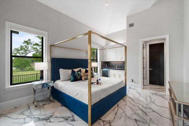 Bedroom featuring visible vents, marble finish floor, baseboards, beverage cooler, and vaulted ceiling | Image 18