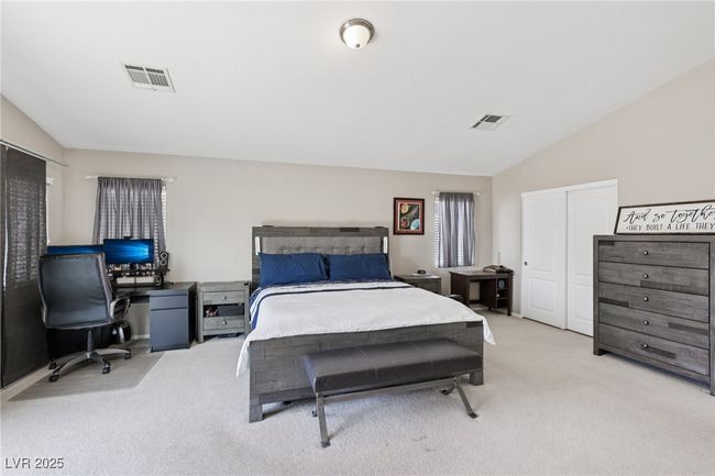 Bedroom with light carpet, vaulted ceiling, an office area, and a closet | Image 48