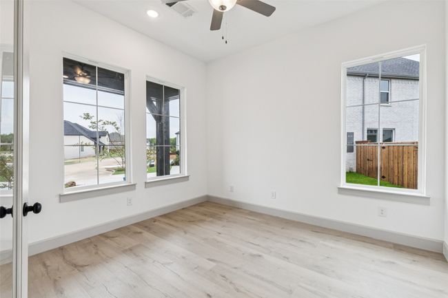 This home office is flooded with natural light and is perfect for the professional needing to work from home. | Image 14
