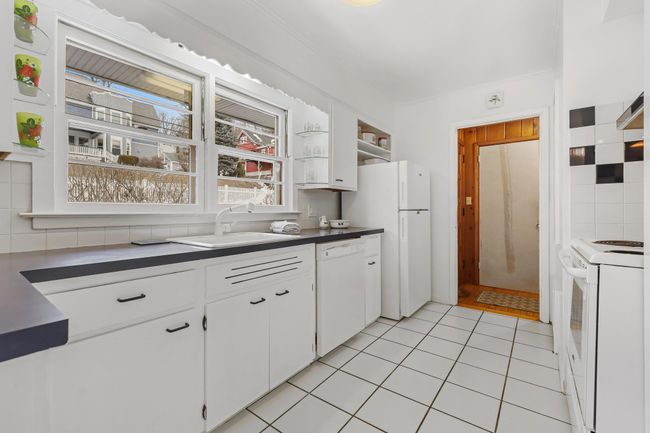 White Kitchen with sink with windows out to front of house | Image 5