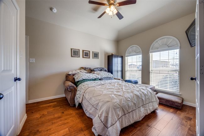 Bedroom with ceiling fan, dark hardwood / wood-style floors, and vaulted ceiling | Image 11