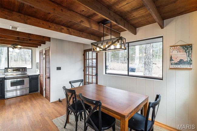 Dining room with beam ceiling, wood ceiling, and wood finished floors | Image 12