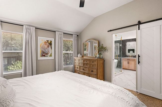 Primary suite with a glimpse into the luxurious ensuite bathroom | Image 19