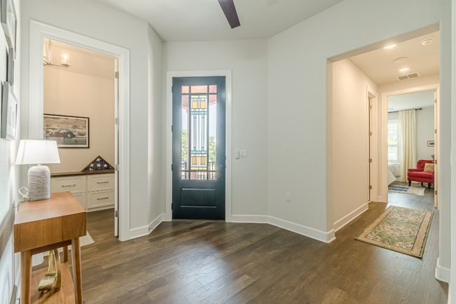 Foyer entrance with dark wood-style floors, a ceiling fan, and baseboards | Image 4