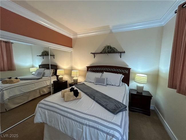 Carpeted bedroom featuring crown molding and baseboards | Image 37