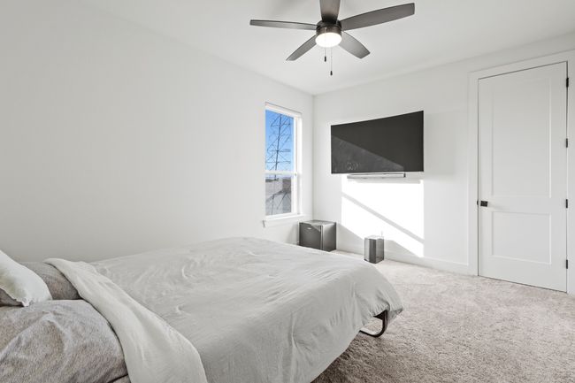 Carpeted bedroom featuring a ceiling fan | Image 26