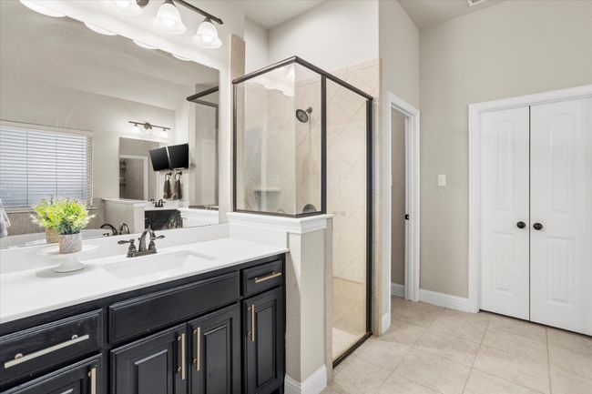 Full bathroom featuring a stall shower, tile patterned flooring, and vanity | Image 20