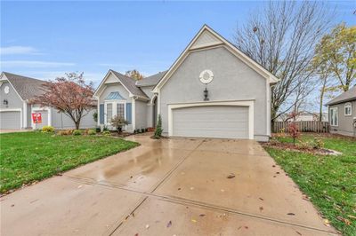 View of front of house featuring a front lawn and a garage | Image 2