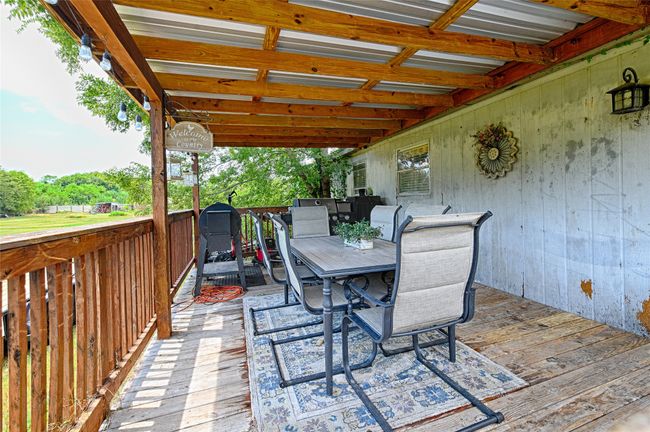 Wooden deck featuring outdoor dining space | Image 26