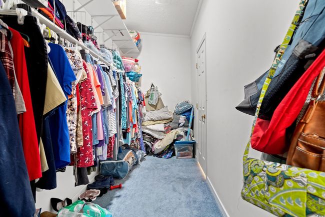 Spacious closet with carpet floors | Image 16