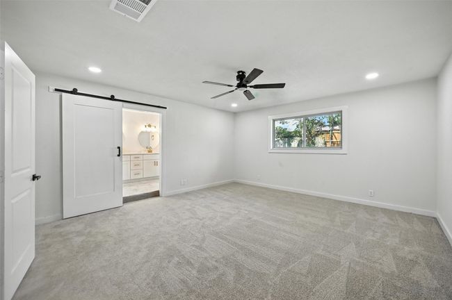 Spacious Primary bedroom with a barn style door to enter ensuite bathroom. | Image 17