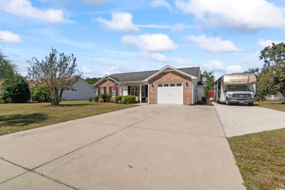 Ranch-style house featuring a front yard and a garage | Image 3