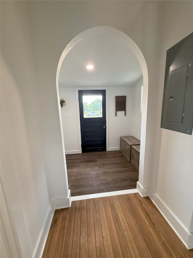 Foyer with arched walkways, electric panel, and wood-type flooring | Image 16