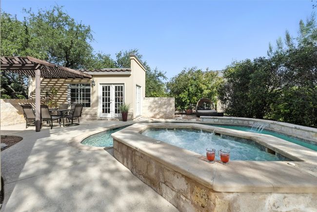 Swimming pool with french doors, an in-ground hot tub, and a patio area | Image 26