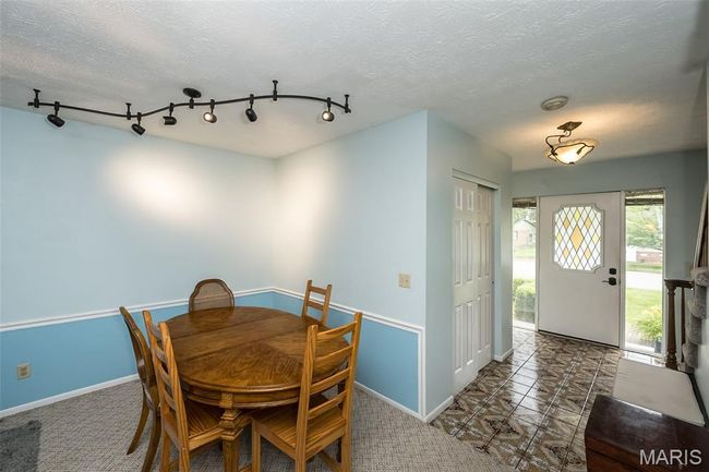 Dining room featuring baseboards, track lighting, and a textured ceiling | Image 21