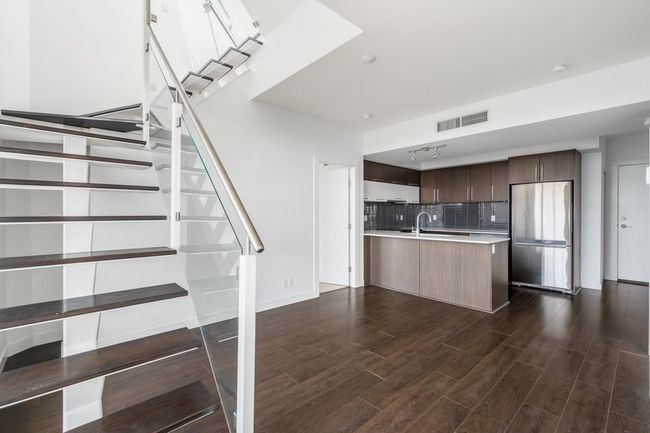 Stairway featuring wood finished floors | Image 13