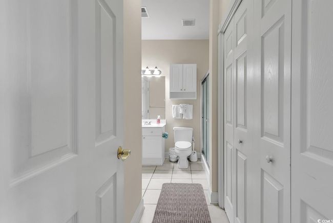 Bathroom with tile patterned floors, vanity, visible vents, and toilet | Image 15