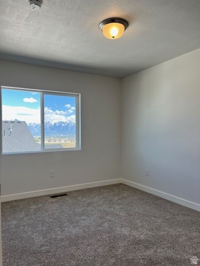 Unfurnished room featuring baseboards, carpet flooring, and visible vents | Image 12