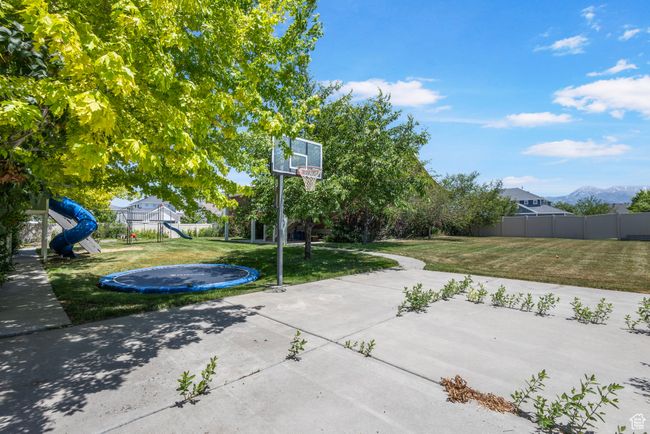 View of patio with a trampoline and a playground | Image 34