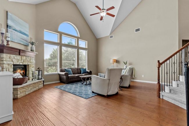A stone fireplace anchors the room with classic charm, perfectly framed by natural light and serene Hill Country views. | Image 15