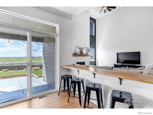 Eat in kitchen with custom built in white oak bar area overlooking the living room! | Image 16