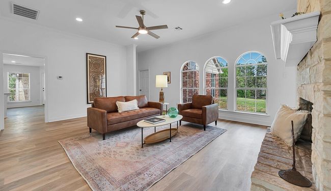 Living area updated light wood-type flooring, new modern ceiling fan, and recessed lighting | Image 7