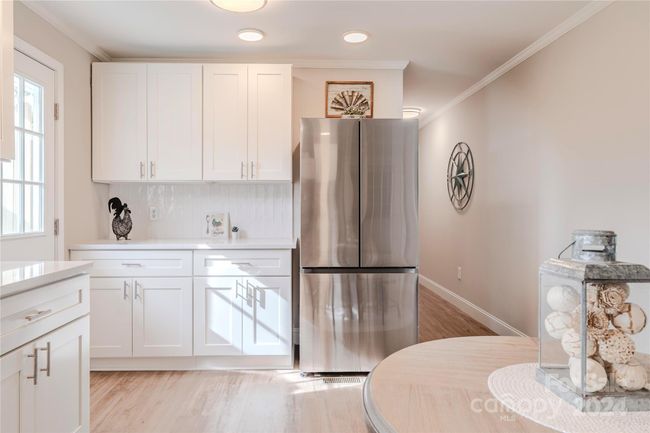 A large counter to the left of the fridge is perfect for a home baker or for party spreads! | Image 13