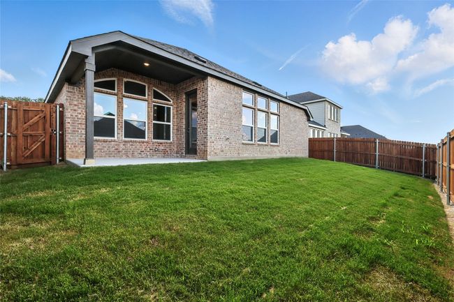 Rear view of property with brick siding, a fenced backyard, a patio area, and a gate | Image 30