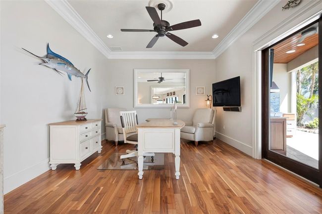 Office area with sliding glass doors to the outdoor kitchen area | Image 34