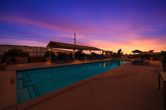 Virtual Staging - Pool at dusk with fence, a fenced in pool, and a patio area | Image 40