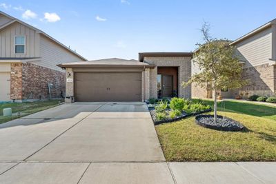 View of front of house with a garage and a front lawn | Image 1