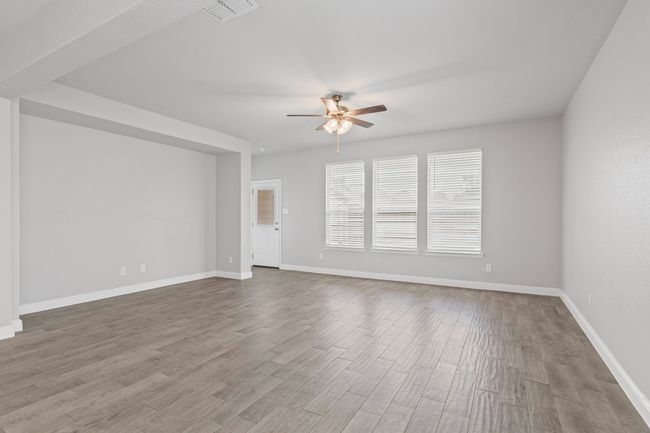 Living Space w Wall of Windows Looking Towards Backyard | Image 11