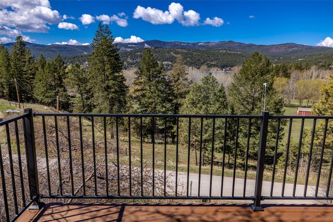 Balcony featuring a wooded view and a mountain view | Image 87