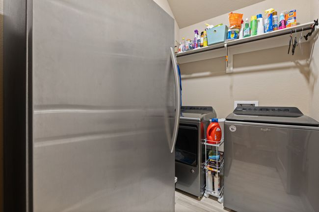 Laundry room with separate washer and dryer and light wood-style floors | Image 14