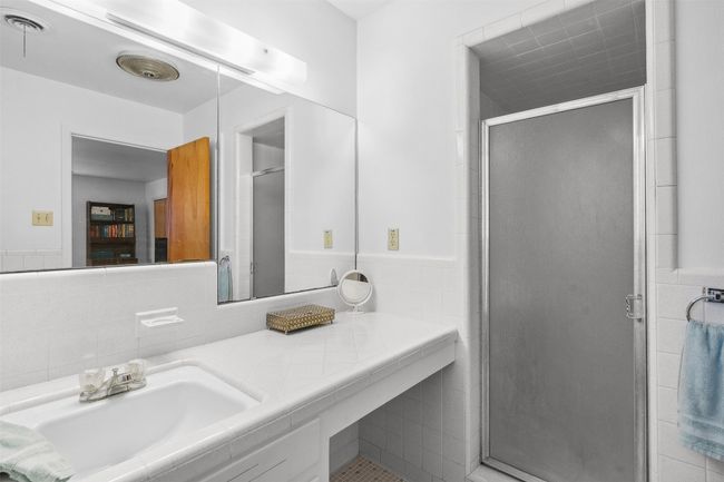 Bathroom featuring vanity, tile walls, and a stall shower | Image 31