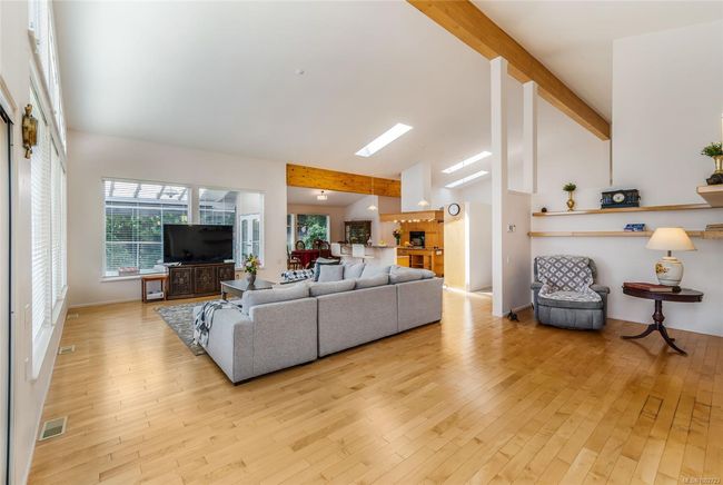 Living room with wood-type flooring, beamed ceiling, and high vaulted ceiling | Image 23