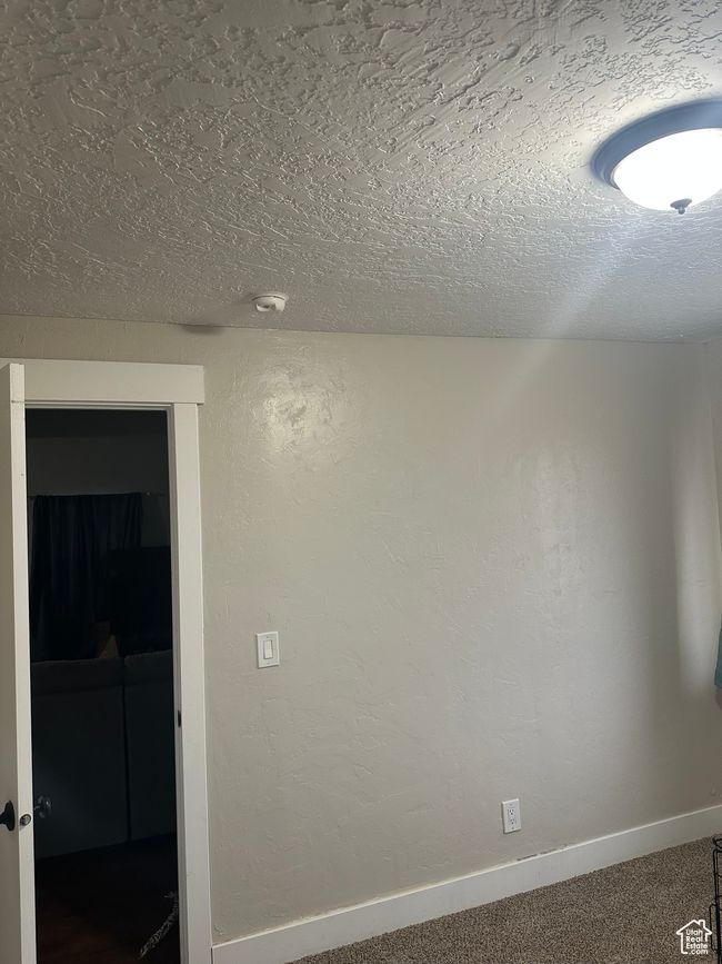 Carpeted empty room featuring a textured ceiling | Image 10