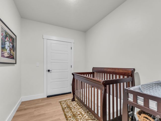 Bedroom with light wood-type flooring and baseboards | Image 39