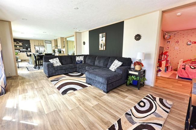 Living area featuring wood finished floors and a textured ceiling | Image 9