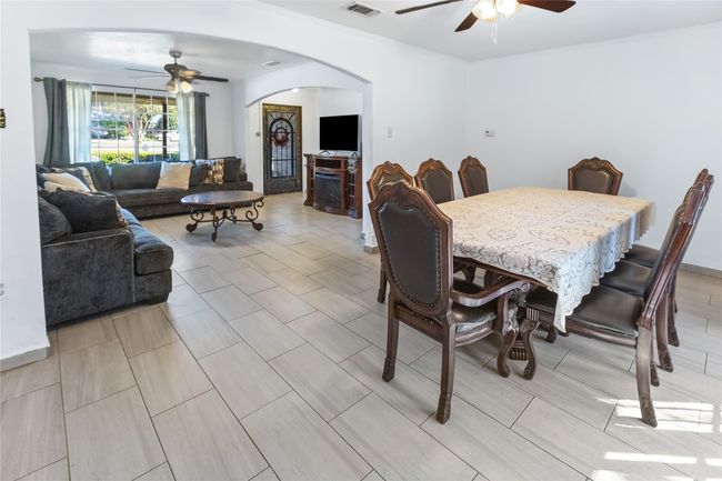 Dining room with a fireplace and ceiling fan | Image 7
