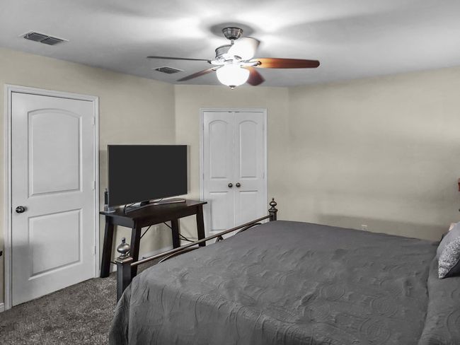 Carpeted bedroom with a ceiling fan and a closet | Image 15