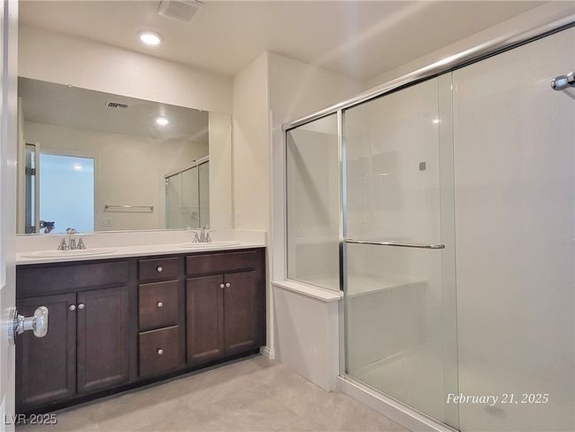 Full bathroom with a shower stall, visible vents, and a sink | Image 16