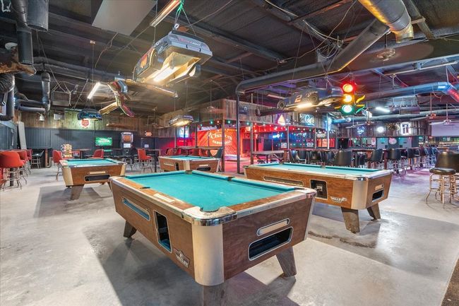Recreation room with pool table, concrete floors, and a community bar | Image 10
